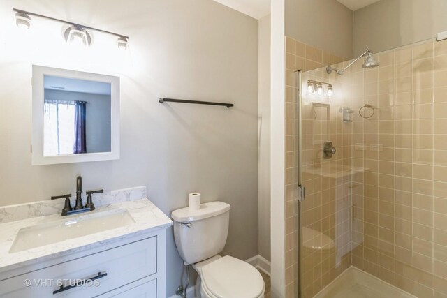 920 Surrey Dr Unit 1A, Schaumburg, IL 60193 - bathroom featuring toilet, vanity, and a stall shower