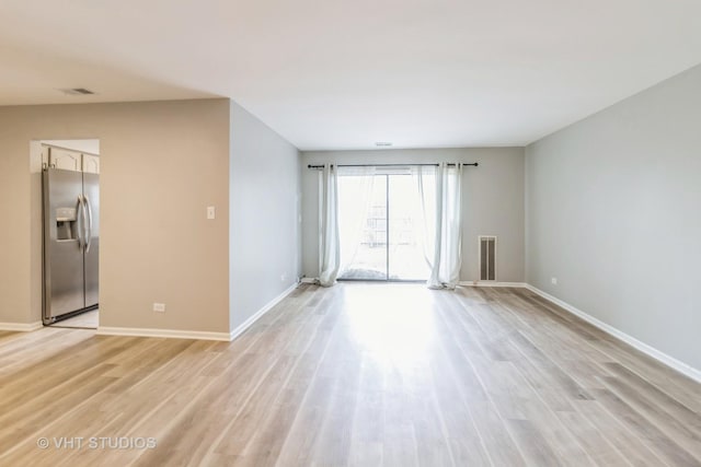 920 Surrey Dr Unit 1A, Schaumburg, IL 60193 - empty room with light wood-type flooring, visible vents, and baseboards