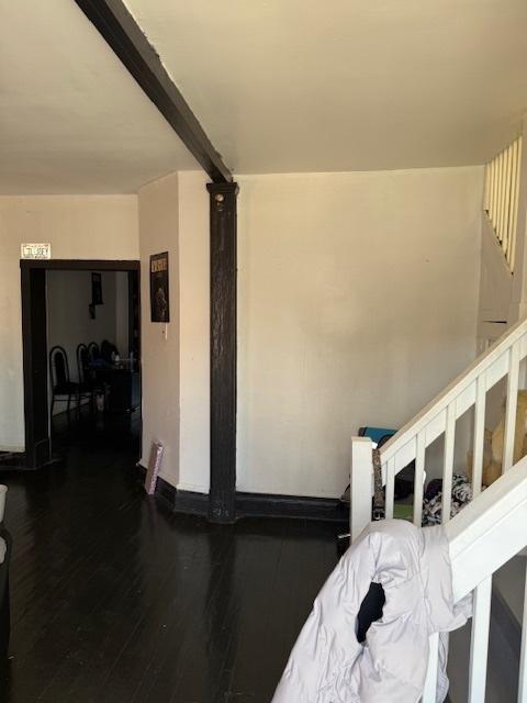 4734 W Monroe St, Chicago, IL 60644 - staircase featuring baseboards, beamed ceiling, and wood finished floors
