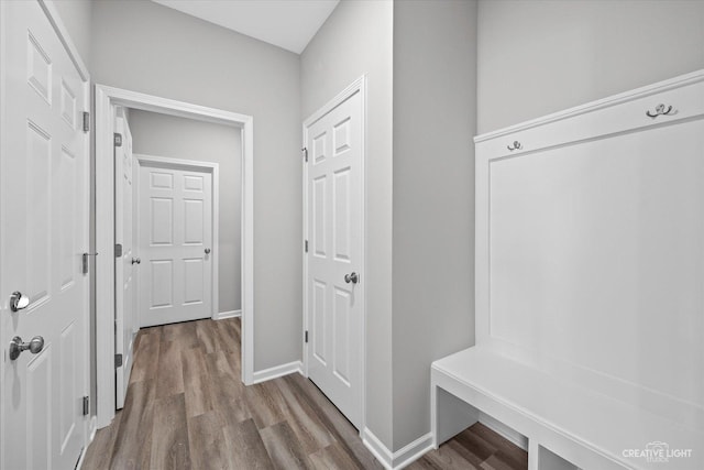 mudroom featuring baseboards and wood finished floors