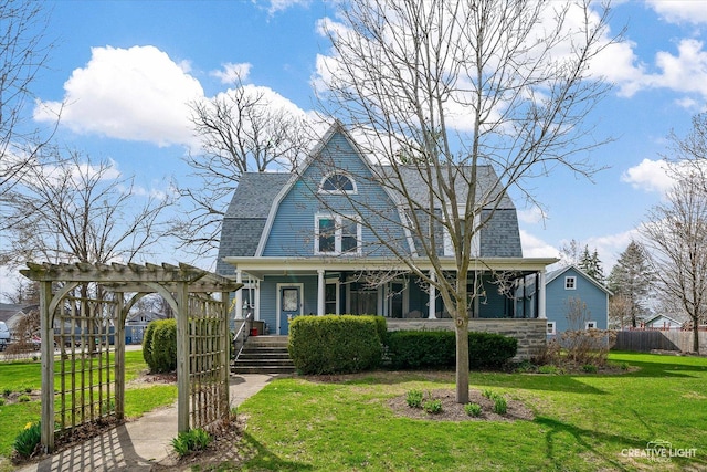 416 Stilson St, Earlville, IL 60518 - view of front of home featuring a front yard, a porch, fence, a gambrel roof, and roof with shingles