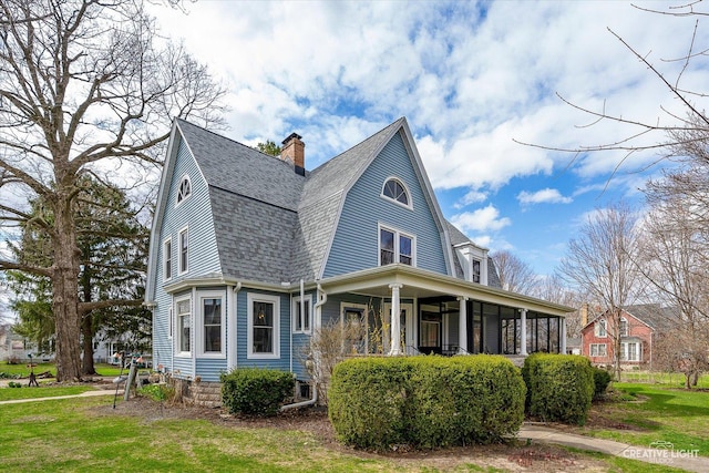 416 Stilson St, Earlville, IL 60518 - view of property exterior with a chimney, a yard, a gambrel roof, a shingled roof, and covered porch