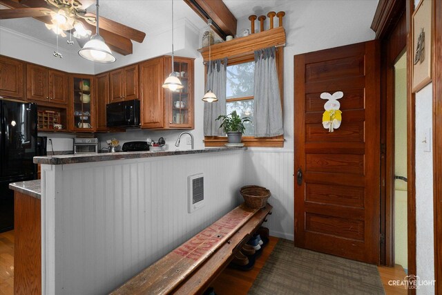 416 Stilson St, Earlville, IL 60518 - kitchen featuring pendant lighting, glass insert cabinets, brown cabinetry, a peninsula, and black appliances