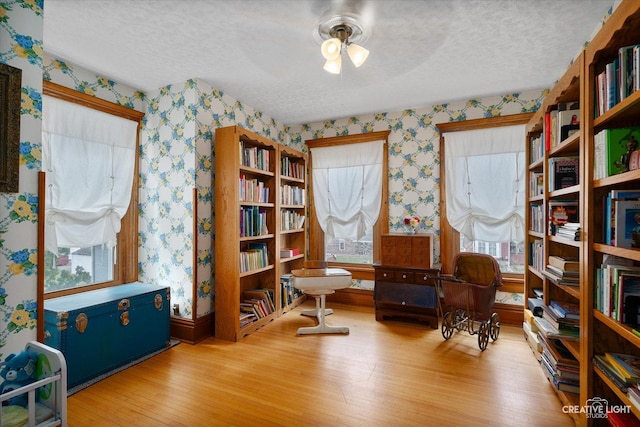 416 Stilson St, Earlville, IL 60518 - sitting room featuring a textured ceiling, wallpapered walls, wood finished floors, and ceiling fan