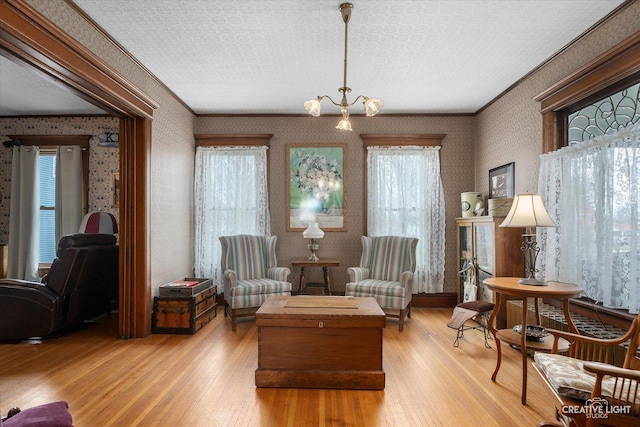 416 Stilson St, Earlville, IL 60518 - sitting room featuring hardwood / wood-style floors, wallpapered walls, and an inviting chandelier