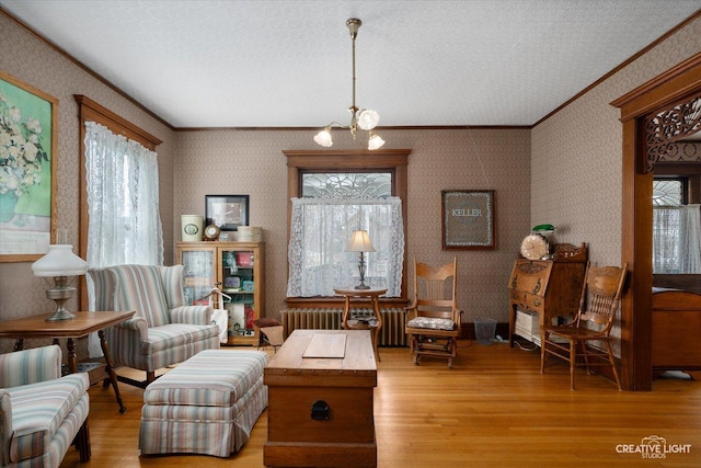 416 Stilson St, Earlville, IL 60518 - living area featuring an inviting chandelier, light wood-type flooring, wallpapered walls, and ornamental molding