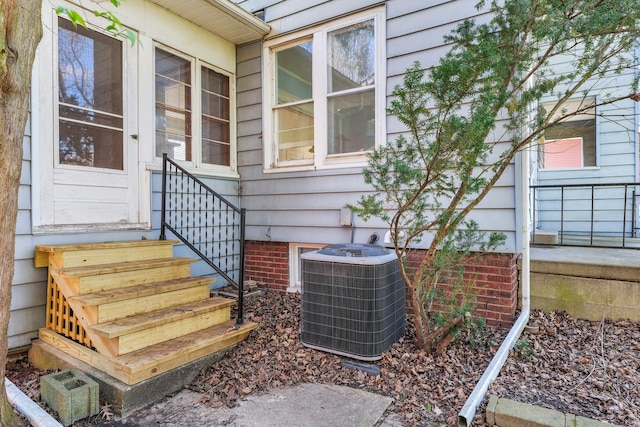 view of exterior entry with central air condition unit