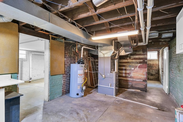 below grade area with brick wall, heating unit, and gas water heater