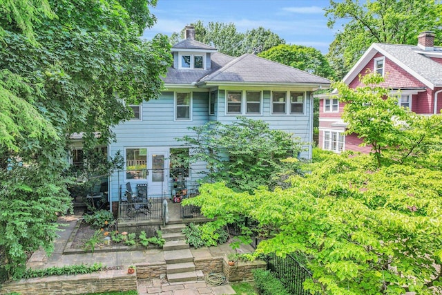 view of front of home featuring a chimney