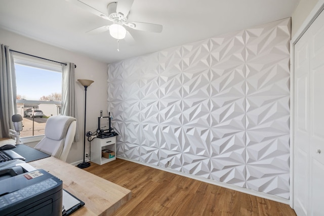 home office with wood finished floors and a ceiling fan