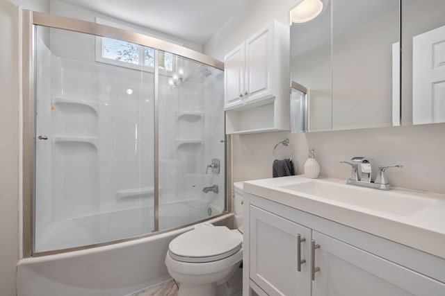 bathroom with shower / bath combination with glass door, toilet, and vanity