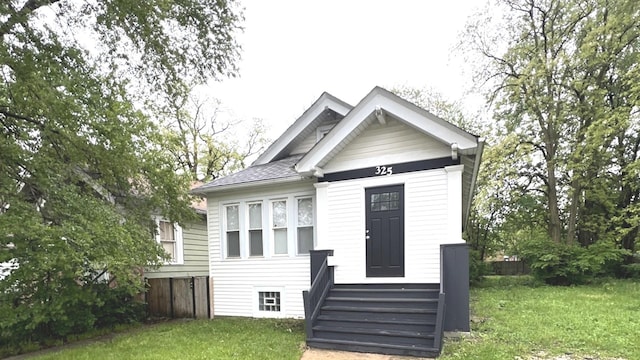 325 W 107th St, Chicago, IL 60628 - view of front of home featuring a front yard and roof with shingles