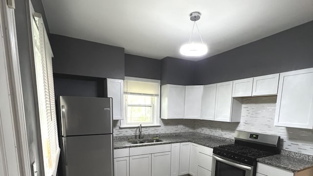 325 W 107th St, Chicago, IL 60628 - kitchen with stainless steel appliances, a sink, decorative backsplash, and white cabinetry