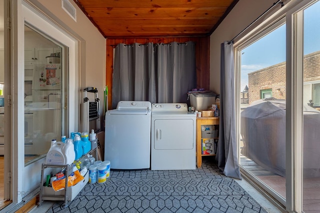 530 N Ashland Ave, Chicago, IL 60622 - clothes washing area with visible vents, washing machine and clothes dryer, wooden ceiling, and laundry area