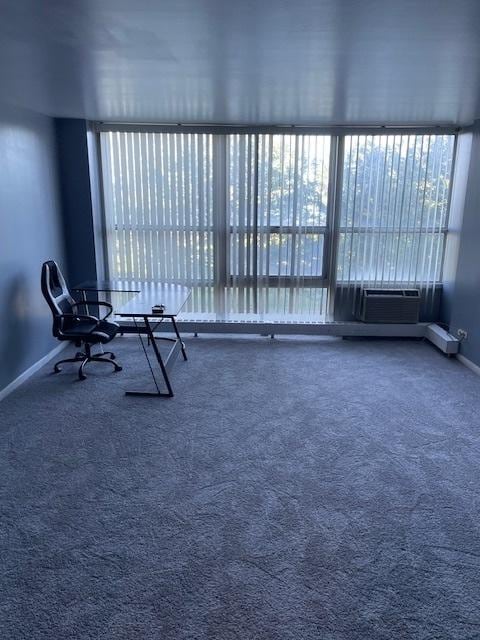 interior space featuring baseboards, carpet flooring, and cooling unit