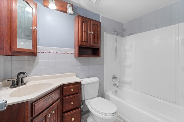 bathroom with tile walls, toilet, shower / bath combination, and vanity