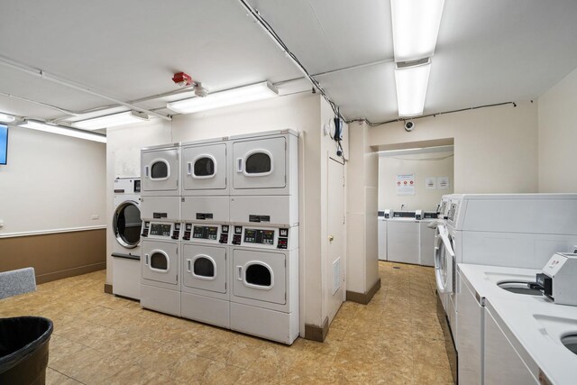 community laundry room featuring stacked washer / dryer and separate washer and dryer