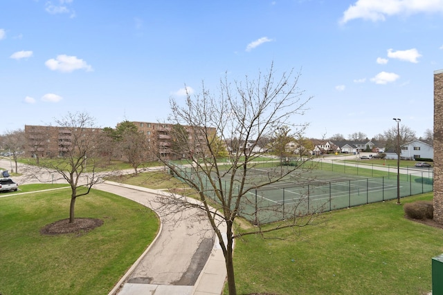 exterior space with a residential view, fence, and a yard