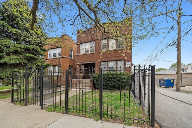 view of front of home with a fenced front yard and brick siding