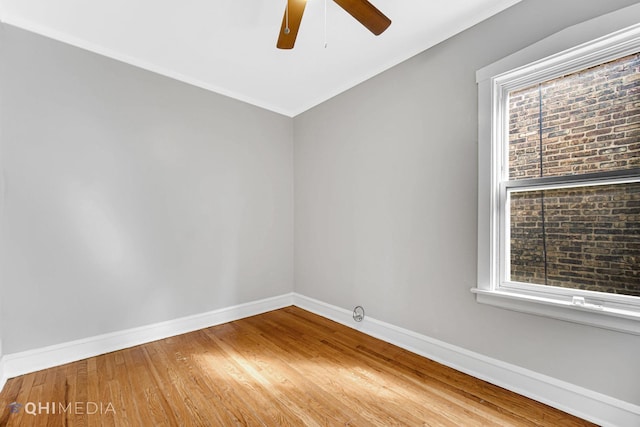 unfurnished room with a ceiling fan, baseboards, and wood finished floors