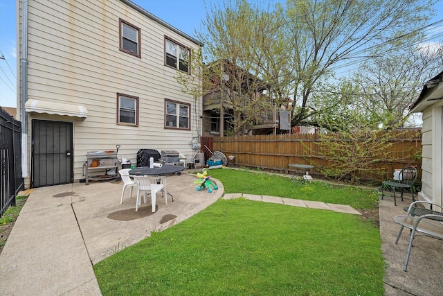 view of yard with a fenced backyard and a patio area