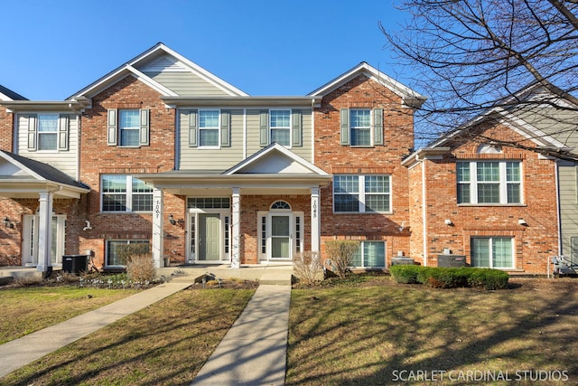 1045 Crane Pt, Elgin, IL 60124 - view of property with a front yard, brick siding, cooling unit, and covered porch