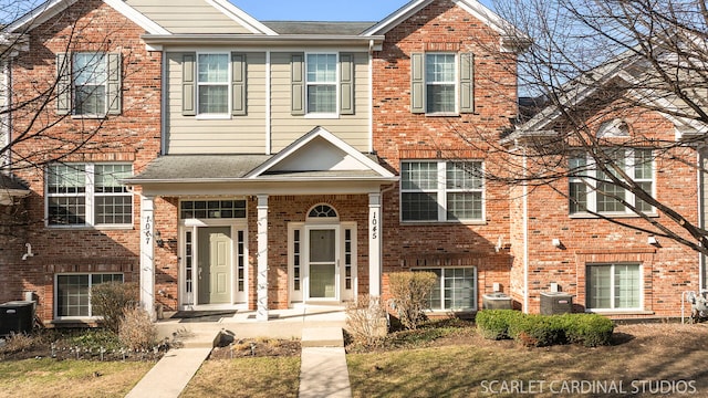 1045 Crane Pt, Elgin, IL 60124 - multi unit property with brick siding, central AC unit, and covered porch