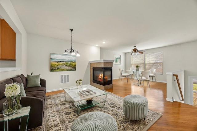 1045 Crane Pt, Elgin, IL 60124 - living room featuring a fireplace, visible vents, a ceiling fan, and wood finished floors