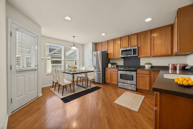 1045 Crane Pt, Elgin, IL 60124 - kitchen with dark countertops, brown cabinets, a sink, and appliances with stainless steel finishes
