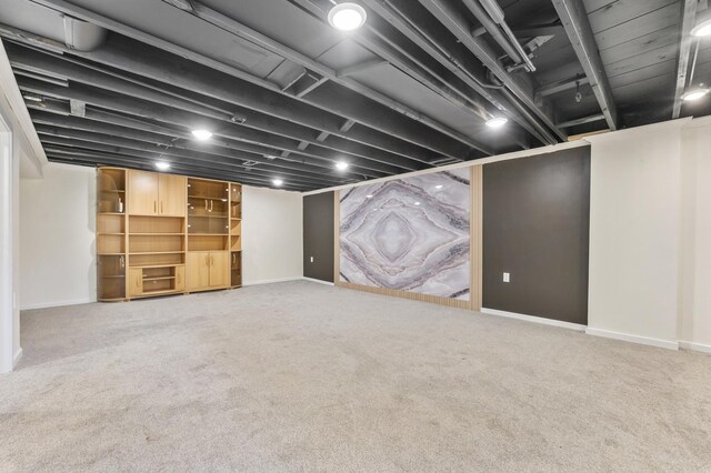 finished basement featuring carpet floors and baseboards