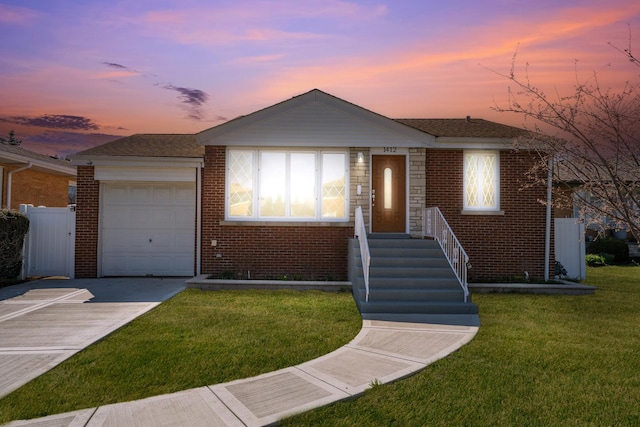 ranch-style home featuring concrete driveway, brick siding, an attached garage, and a front lawn
