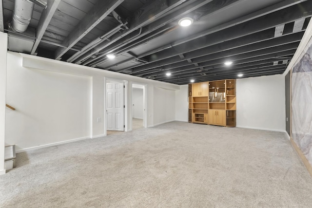 finished basement featuring carpet floors and baseboards