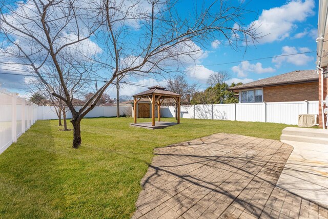 view of yard with a gazebo, a patio area, and a fenced backyard