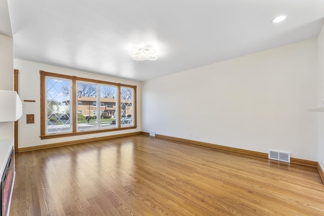 unfurnished living room with visible vents, baseboards, recessed lighting, and wood finished floors