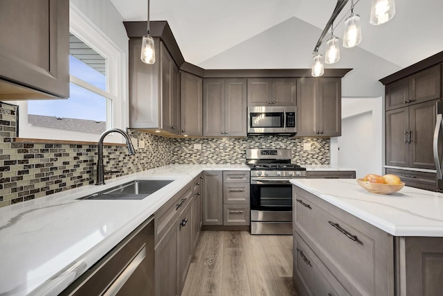 623 Coneflower Ct, Romeoville, IL 60446 - kitchen featuring lofted ceiling, light wood-style flooring, decorative backsplash, stainless steel appliances, and a sink