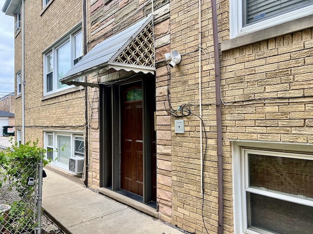 doorway to property with stone siding and brick siding