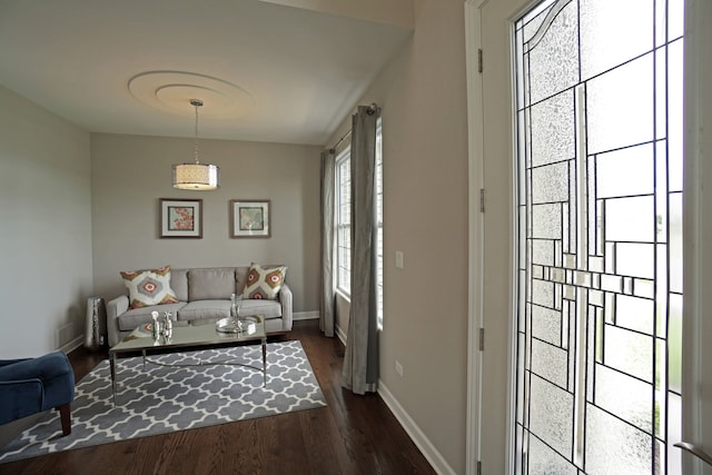 living area with dark wood-style floors and baseboards