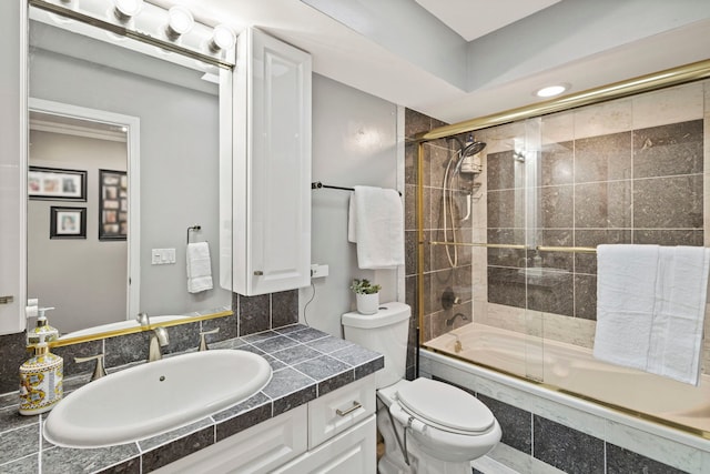 bathroom with tiled shower / bath, toilet, and vanity