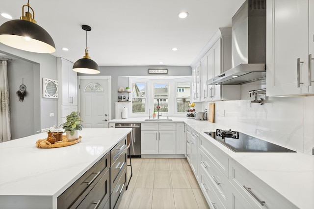 kitchen with white cabinets, wall chimney range hood, stainless steel dishwasher, a sink, and black electric stovetop