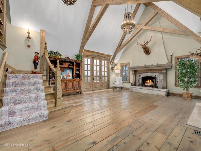 29W221 Oak Knoll Rd, West Chicago, IL 60185 - unfurnished living room with high vaulted ceiling, hardwood / wood-style flooring, a fireplace, stairway, and a notable chandelier