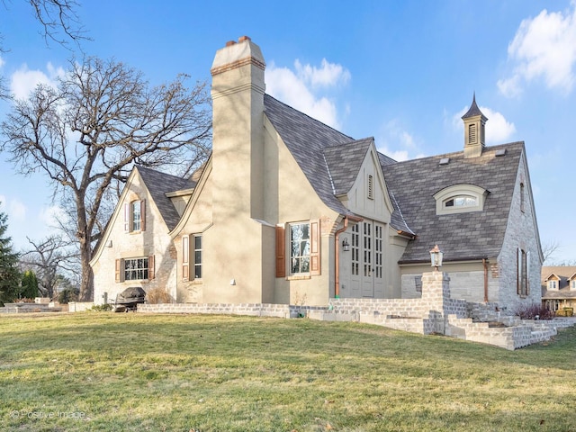 29W221 Oak Knoll Rd, West Chicago, IL 60185 - rear view of property with a lawn, a chimney, and stucco siding