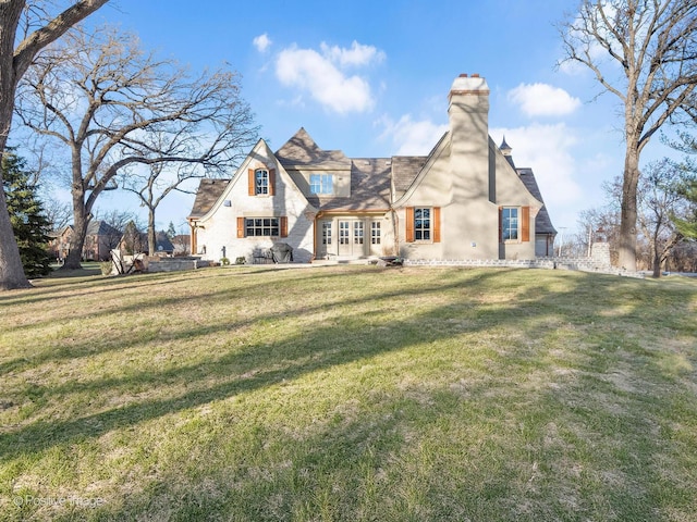 29W221 Oak Knoll Rd, West Chicago, IL 60185 - back of property with a lawn, a chimney, and french doors