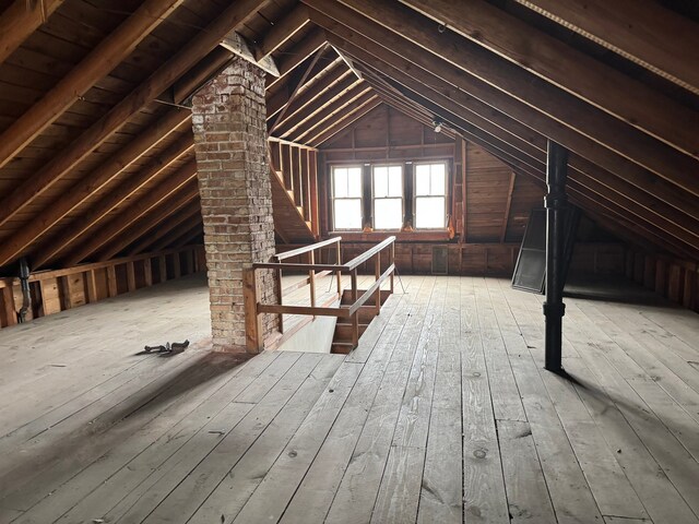 unfinished attic with an upstairs landing