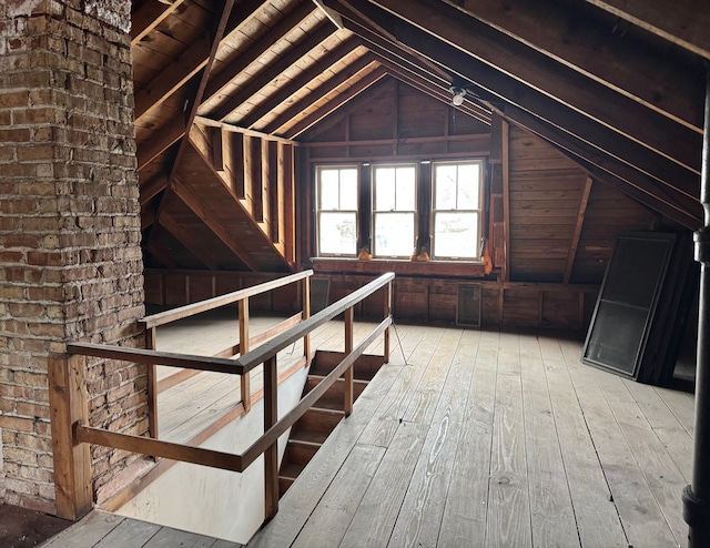 unfinished attic featuring an upstairs landing