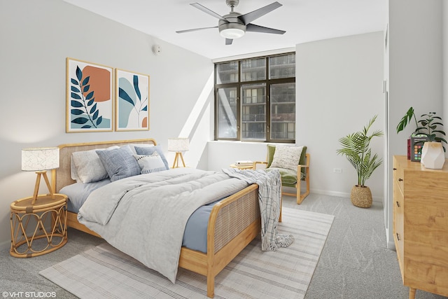 bedroom featuring carpet, baseboards, and a ceiling fan