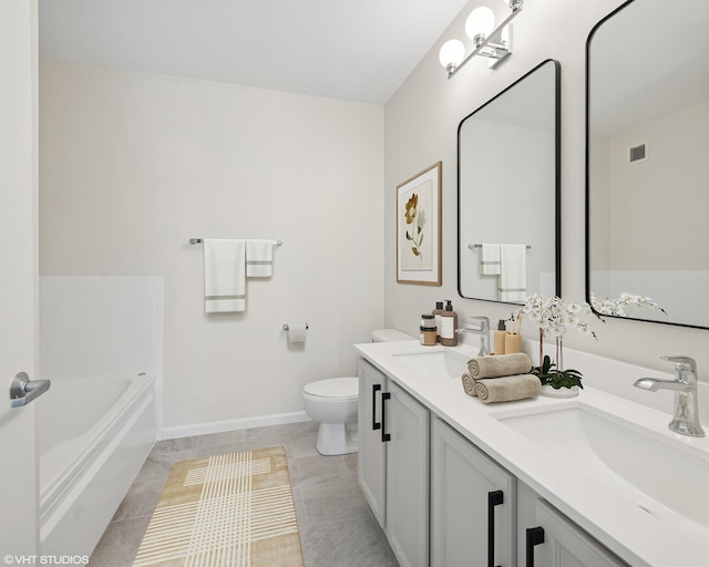 bathroom with toilet, baseboards, a bathtub, and double vanity