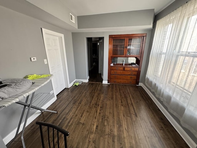 5120 S Throop St, Chicago, IL 60609 - unfurnished dining area featuring dark wood-style floors, baseboards, and visible vents