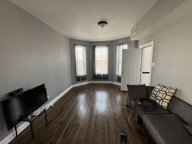 5120 S Throop St, Chicago, IL 60609 - unfurnished living room with dark wood-style floors, baseboards, and visible vents
