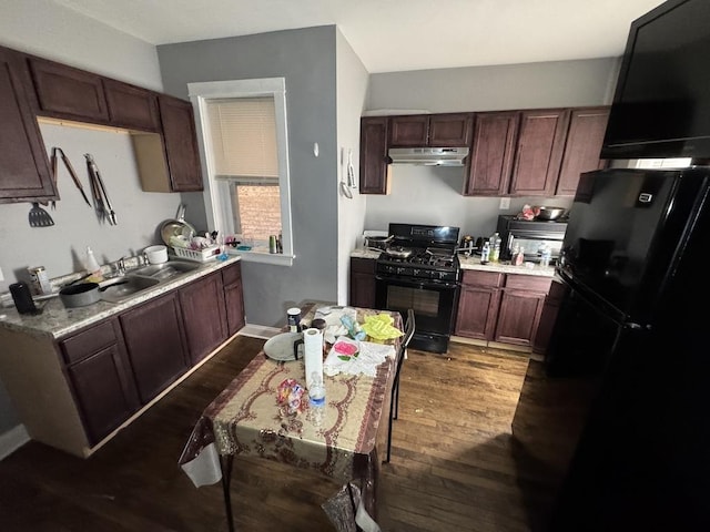 5120 S Throop St, Chicago, IL 60609 - kitchen featuring light countertops, a sink, under cabinet range hood, black appliances, and dark wood-type flooring