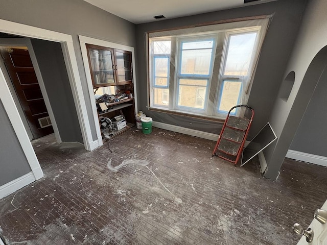 5120 S Throop St, Chicago, IL 60609 - unfurnished dining area with arched walkways, baseboards, and visible vents